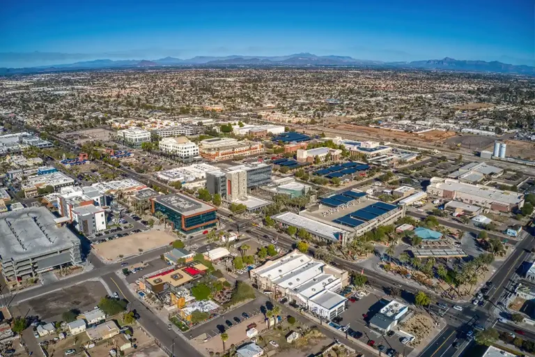 Aerial panorama of Downtown Gilbert Arizona with East Valley neighborhoods and mountain views